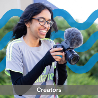 Smiling young woman wearing glasses with a camera